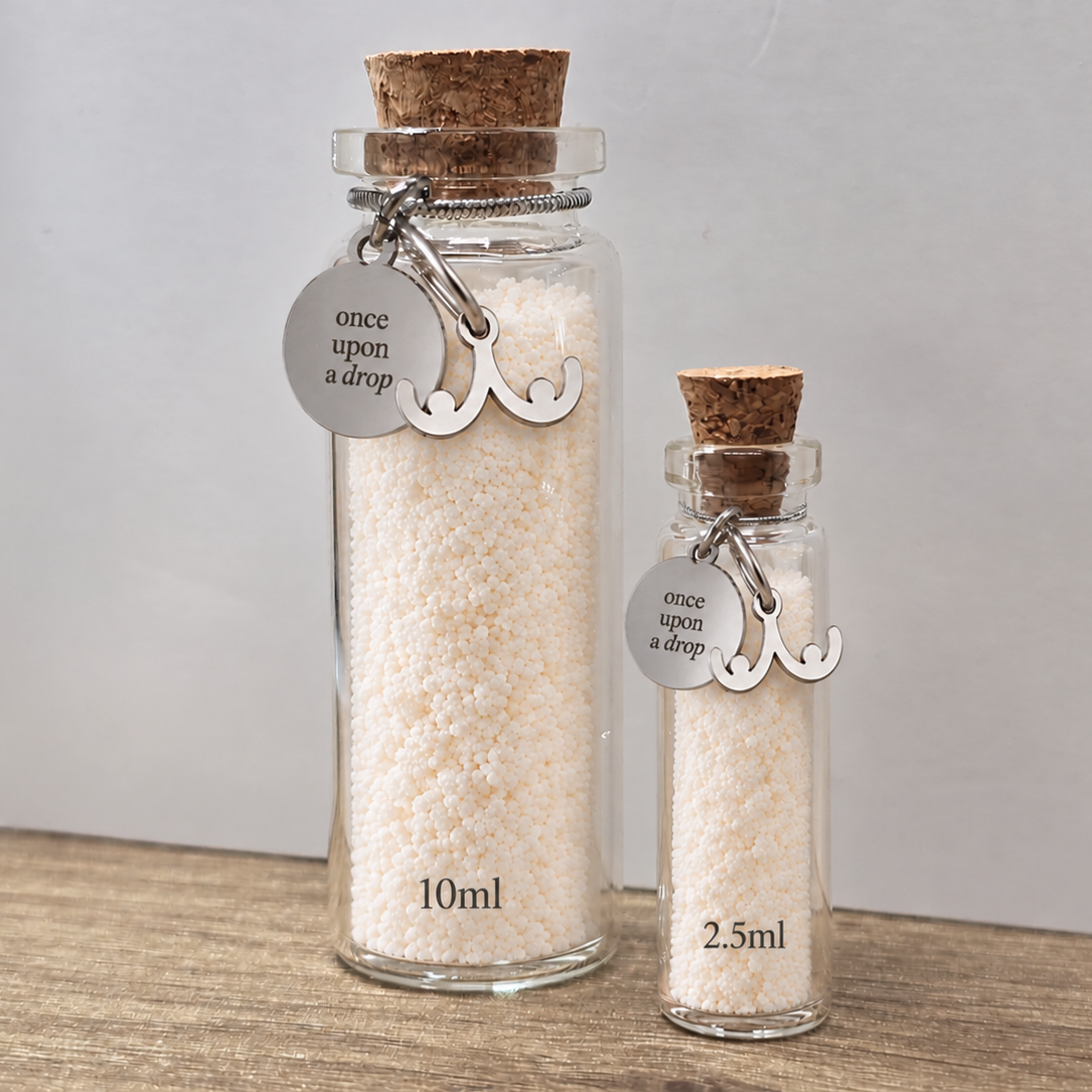 Small glass bottle filled with preserved breastmilk granules from the Once Upon a Drop collection, creating a sentimental keepsake of a breastfeeding journey.